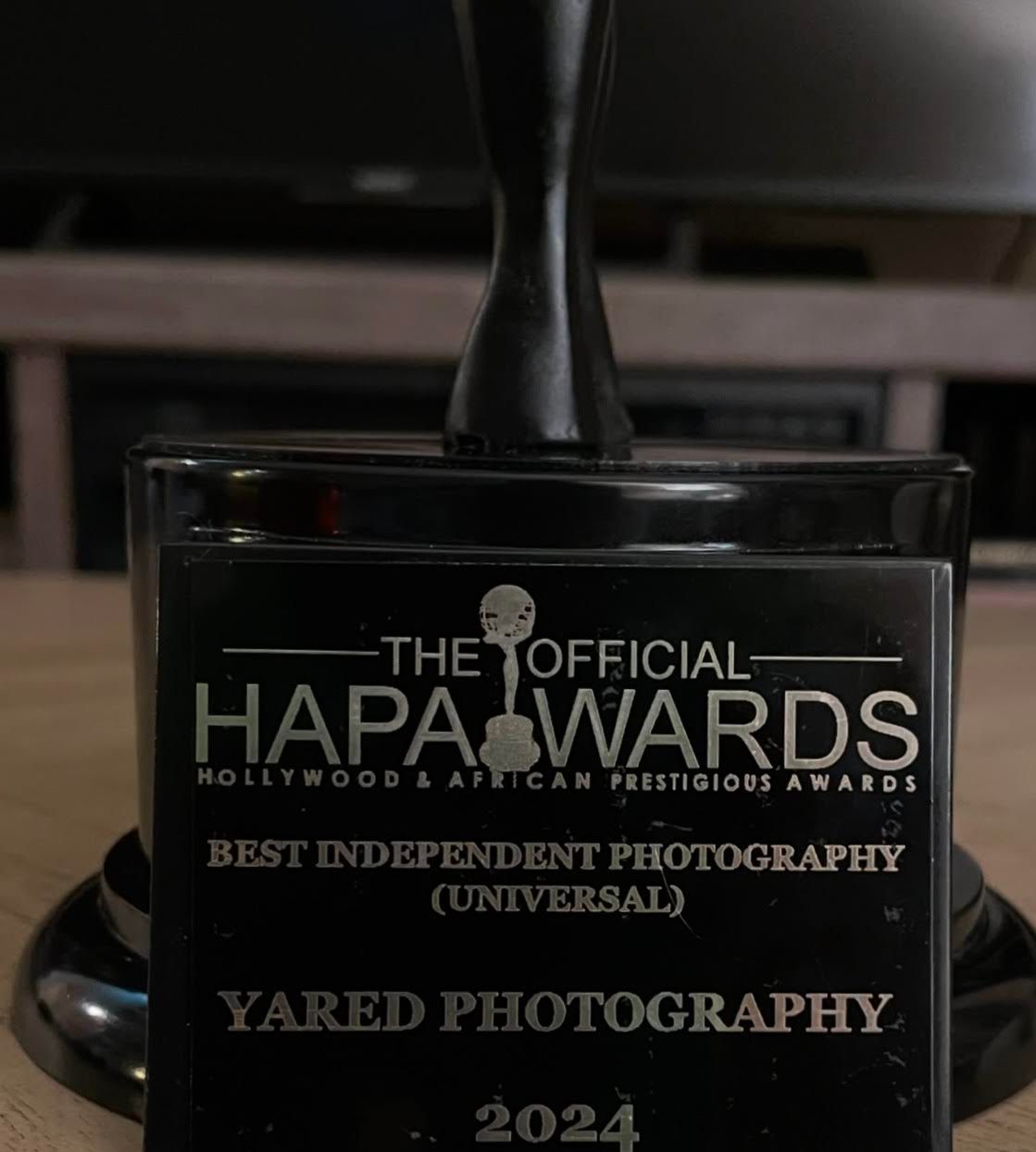 Black award trophy for HAPA Best Independent Photography displayed on dark surface.