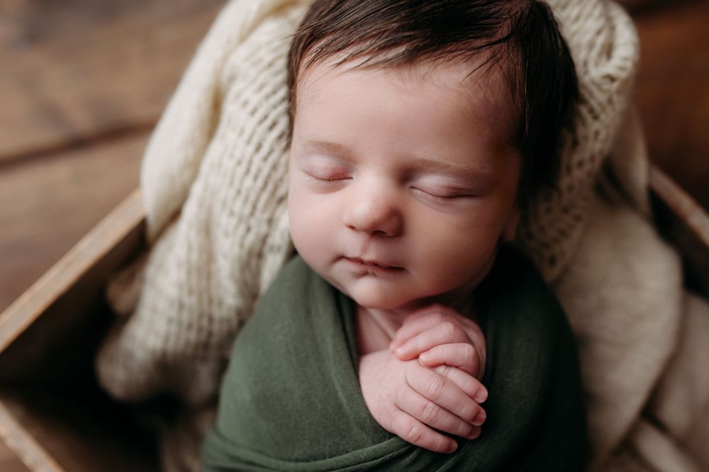 green and neutral newborn up close