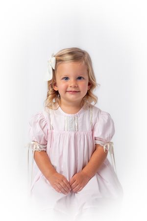 Heirloom photo of blonde girl with pink smocked dress taken by Star Jamison Photography, portrait photographer.
