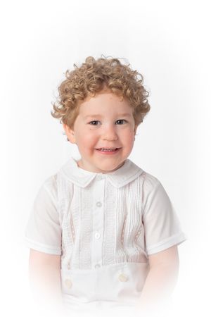 Heirloom child photographic portrait of a boy with curly blonde hair in a traditional peter ban collar outfit.