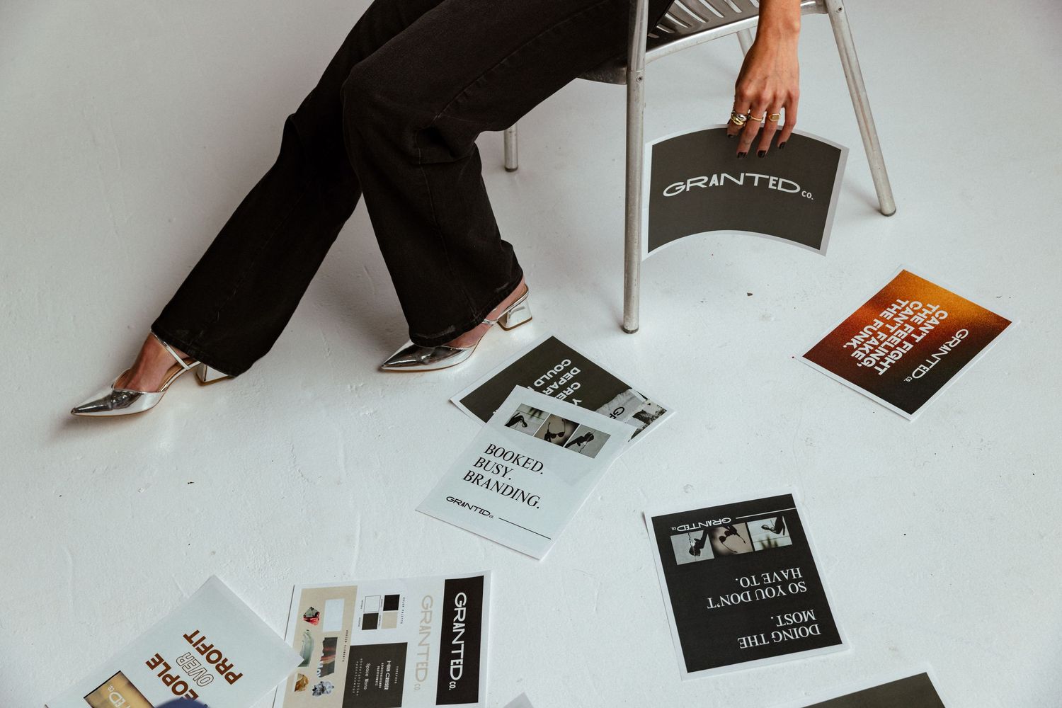 Lifestyle branding image of a designer surrounded by agency materials, capturing the energy of a modern creative studio.
