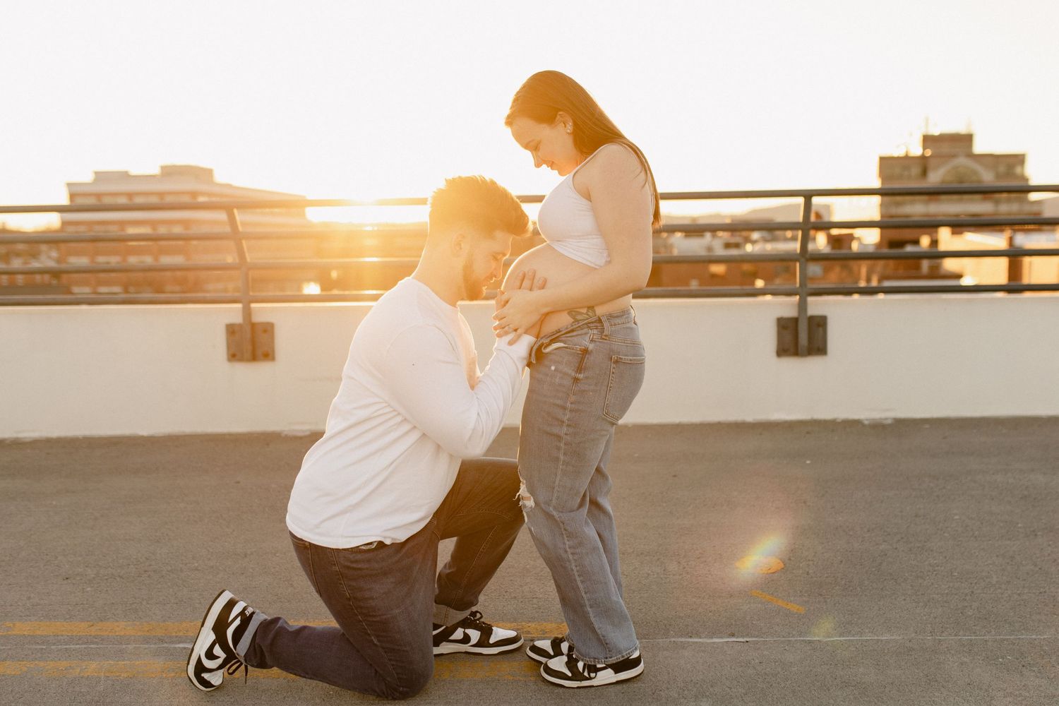 A romantic sunset photoshoot on a rooftop with golden hour lighting.