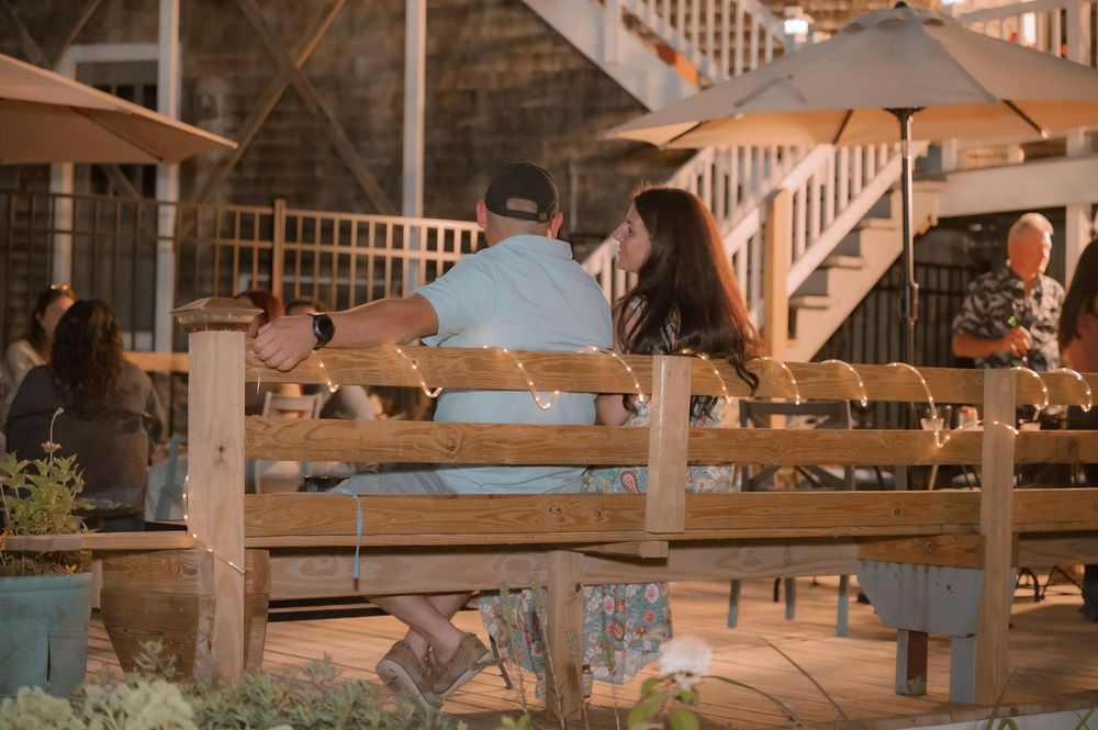Interior view of a rustic wooden space with exposed beams and stairs.
