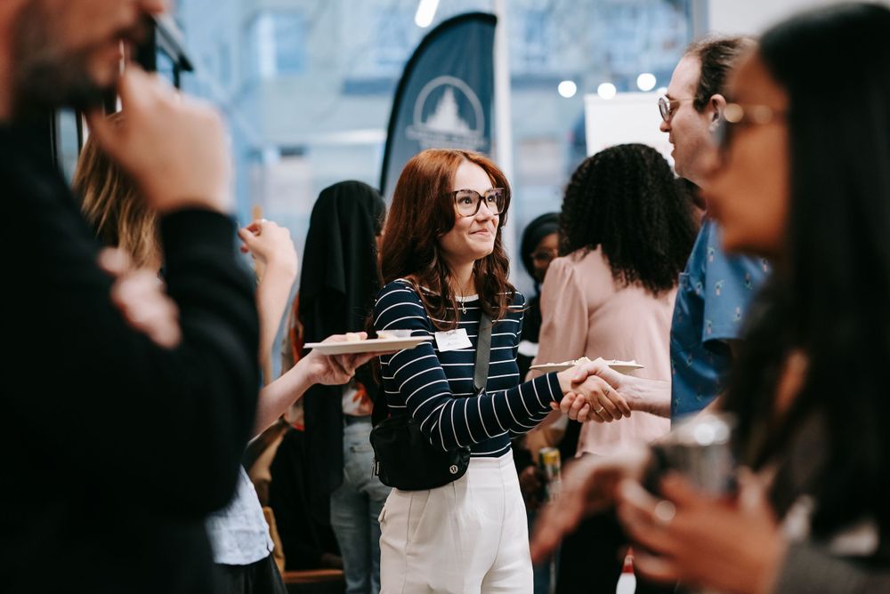 Attendees mingling and networking at a professional business event.