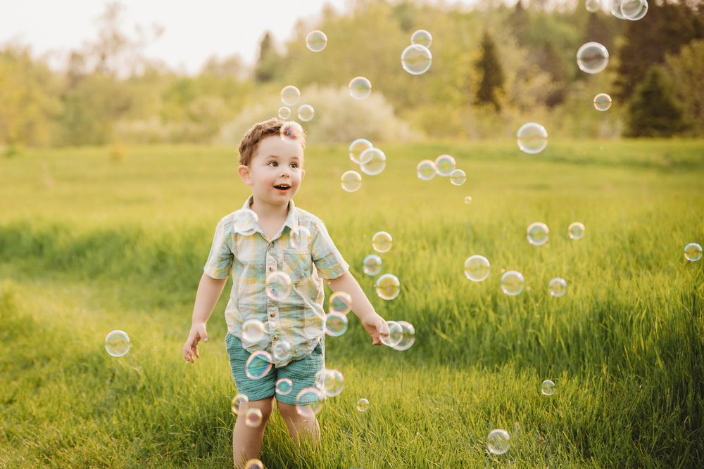 Delightful scene of bubbles floating through a sunny meadow on a warm summer day.
