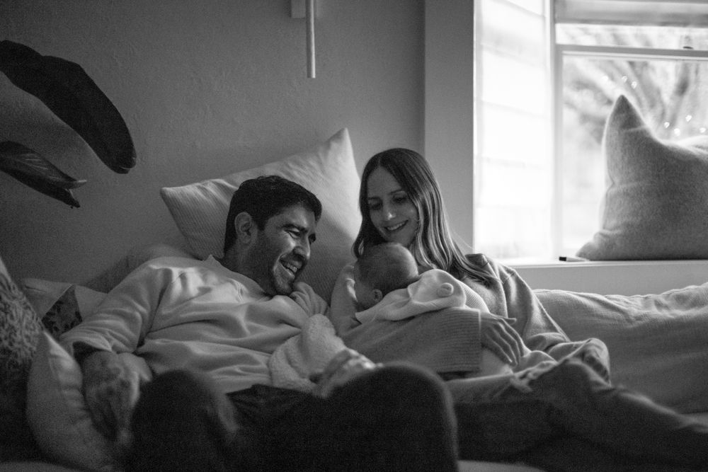 A candid black and white photo capturing joyful moments at home.
