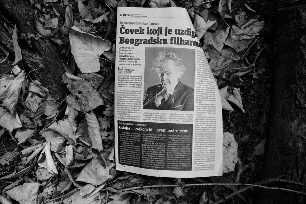A paper with "In Memoriam" article lying on Autumn leaves in Koshutnjak, Belgrade, Serbia.