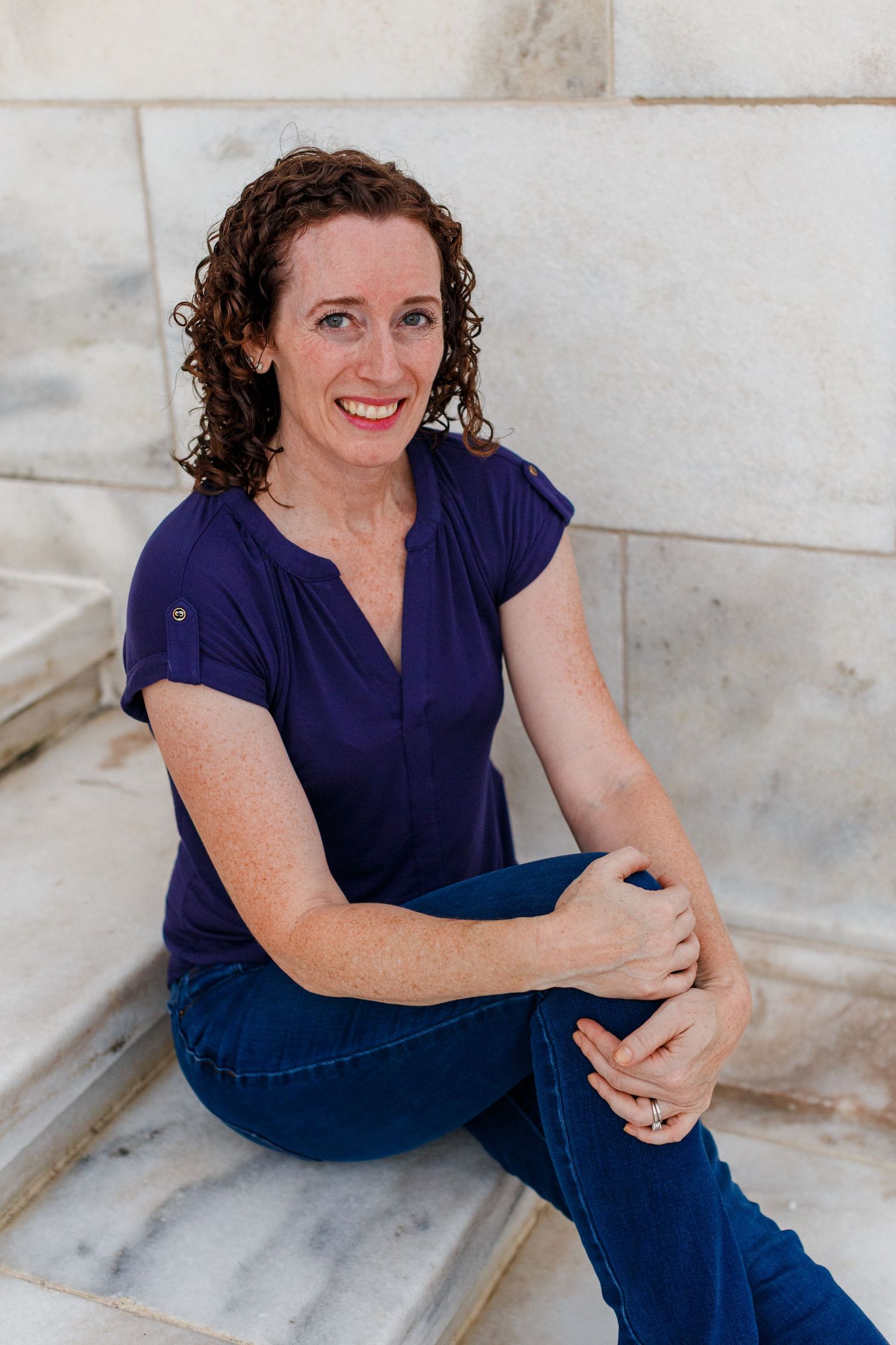 Portrait of a woman sitting on the steps of the capitol building in San Juan, Puerto Rico.