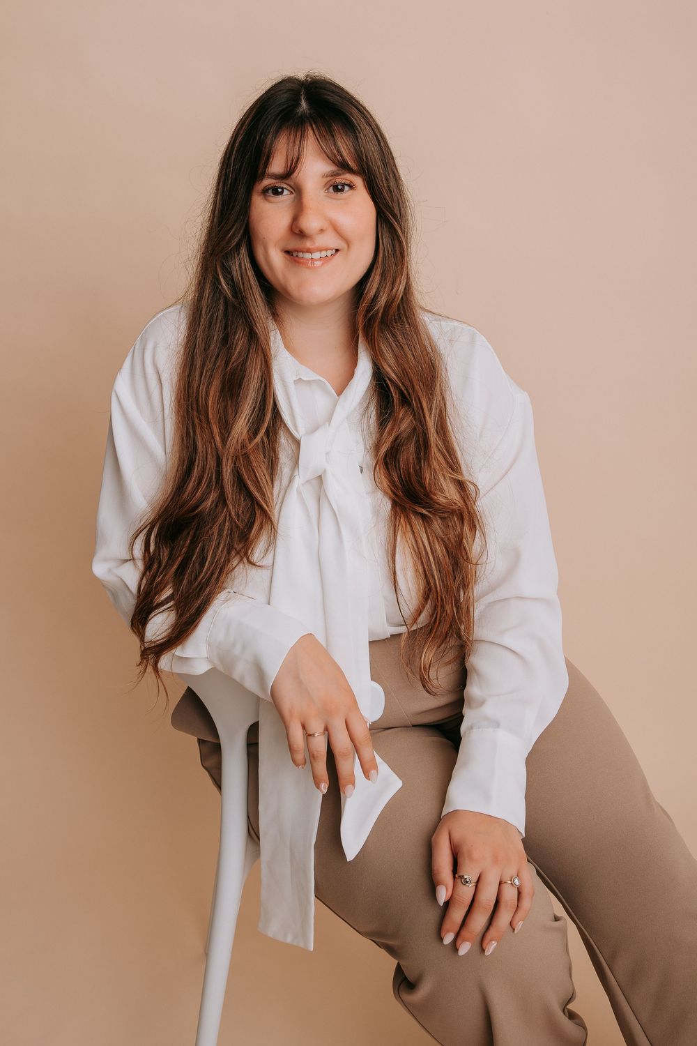 Professional portrait series showing a person in a white blouse against a neutral beige background with warm lighting.