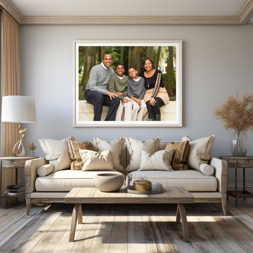 Living room interior with large framed photo above beige sofa, decorative pillows, and modern side tables.