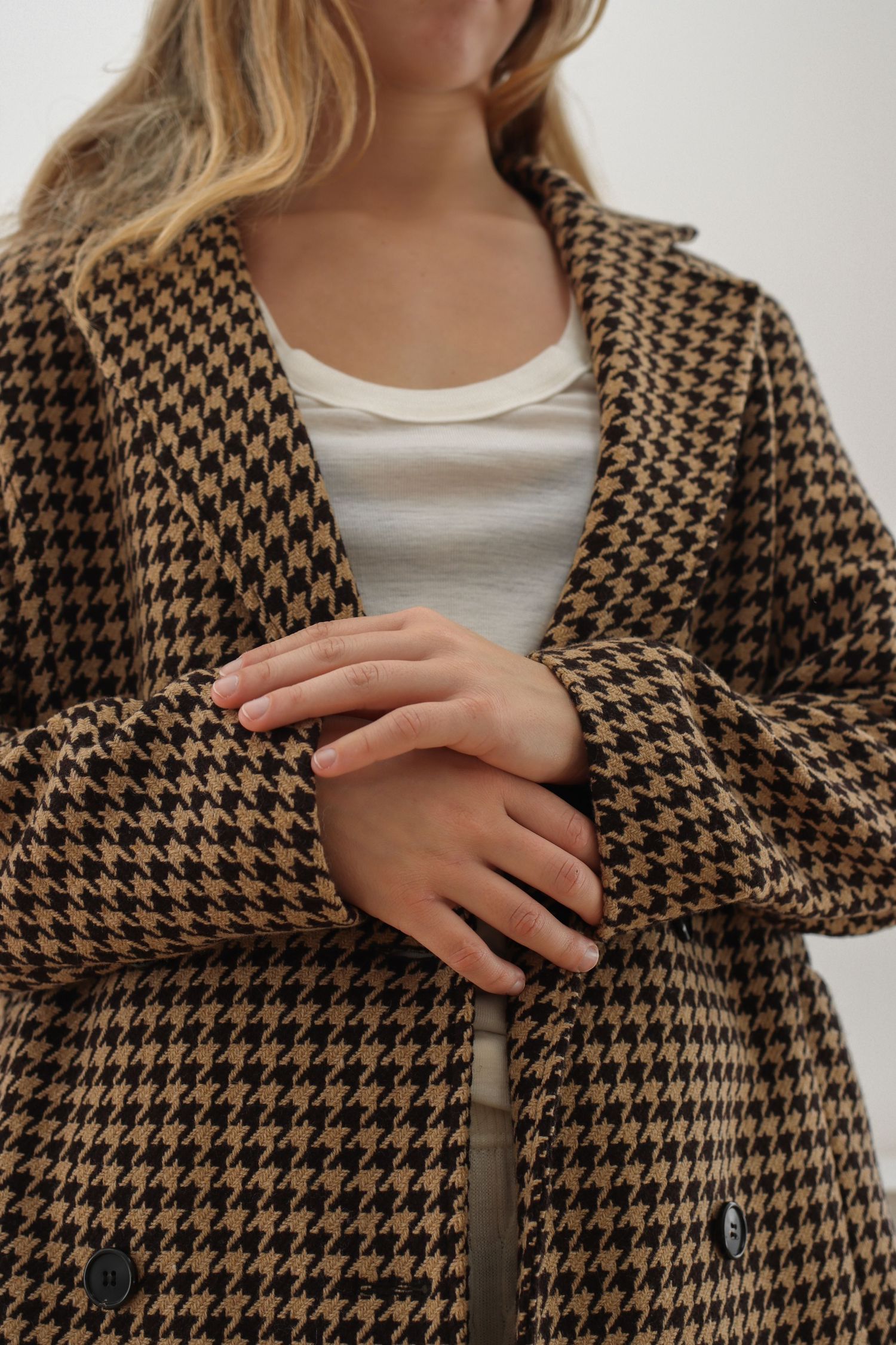 Brown and black houndstooth pattern coat shown in detail shots.