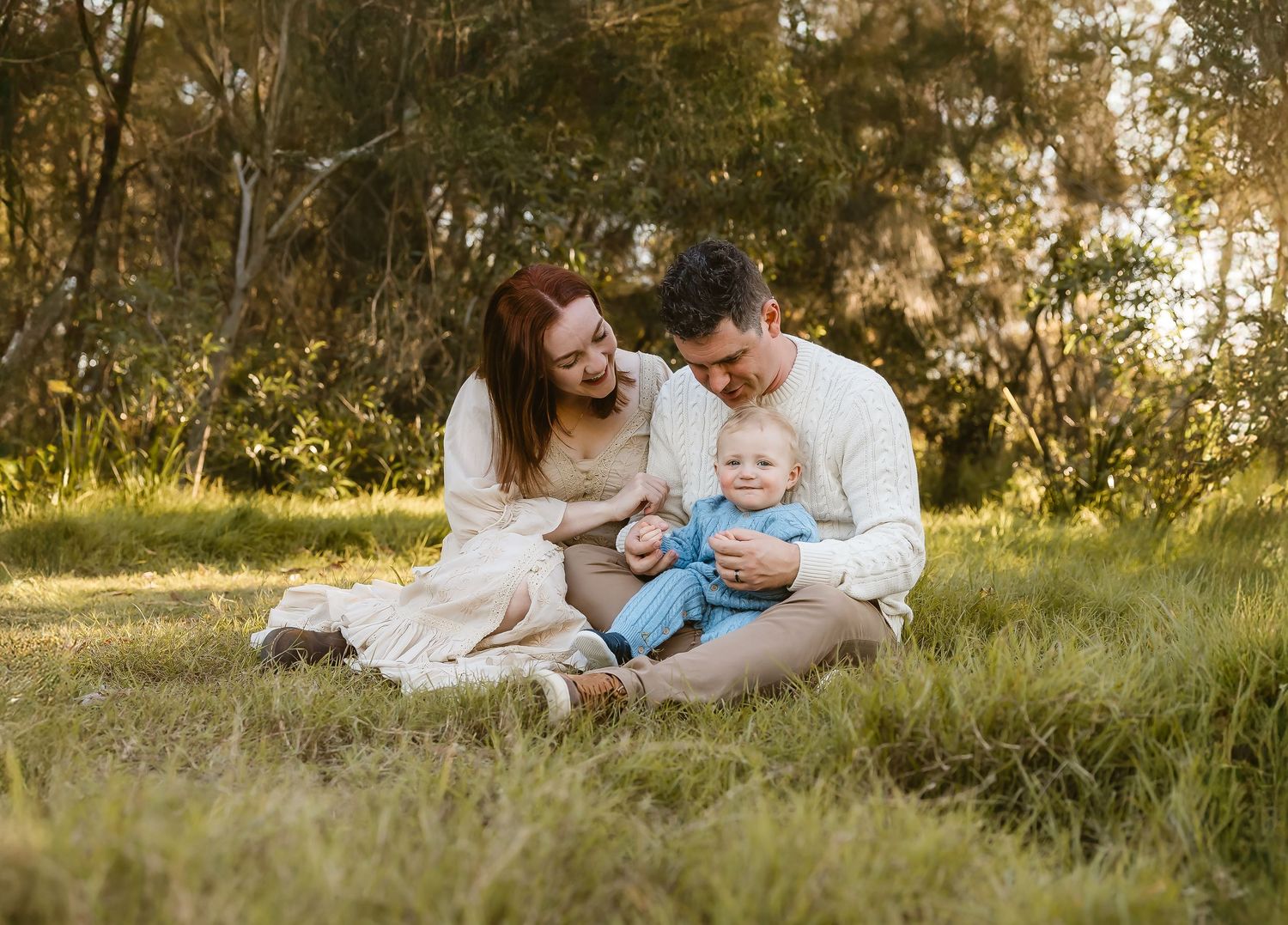 Couple hugging under tree during family photo shoot in Arana Hills, Brisbane