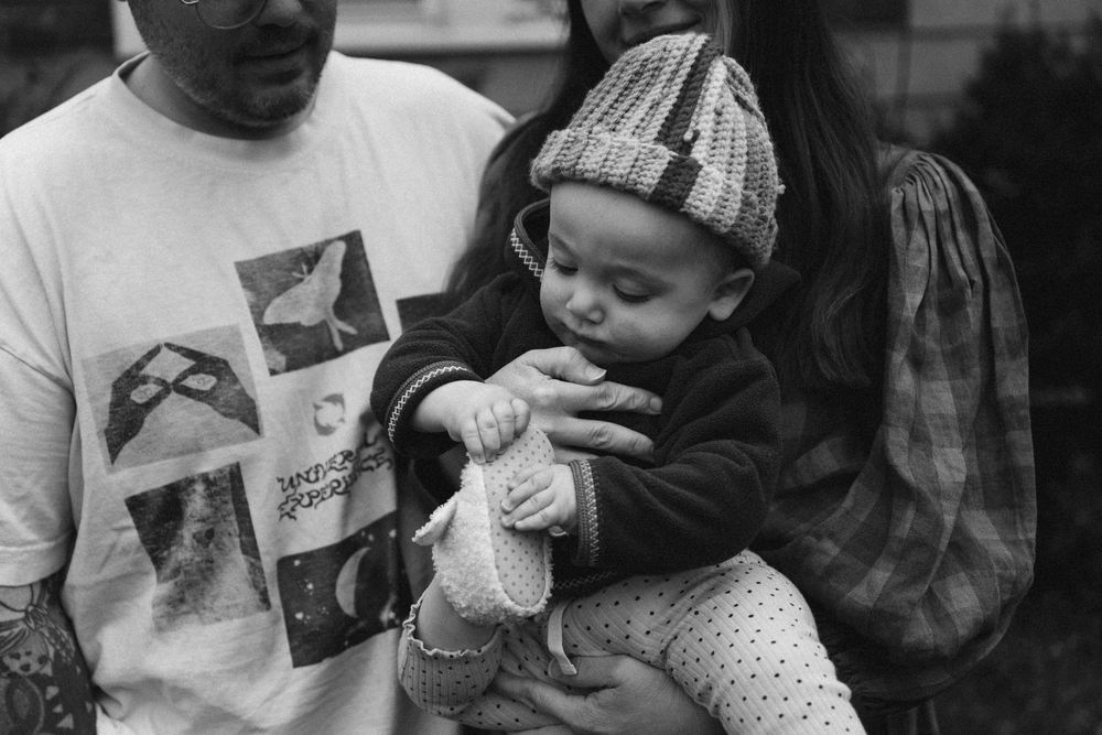 A candid black and white portrait of a family taken by West Hartford family photographer Anaise Prince.