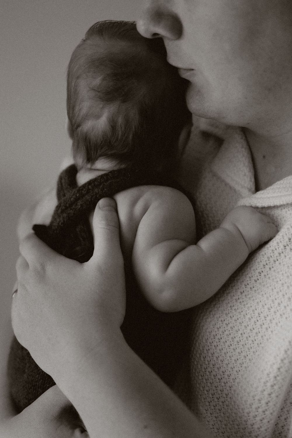 A series of black and white photographs showing an intimate close-up of a tender kiss in progressive frames.