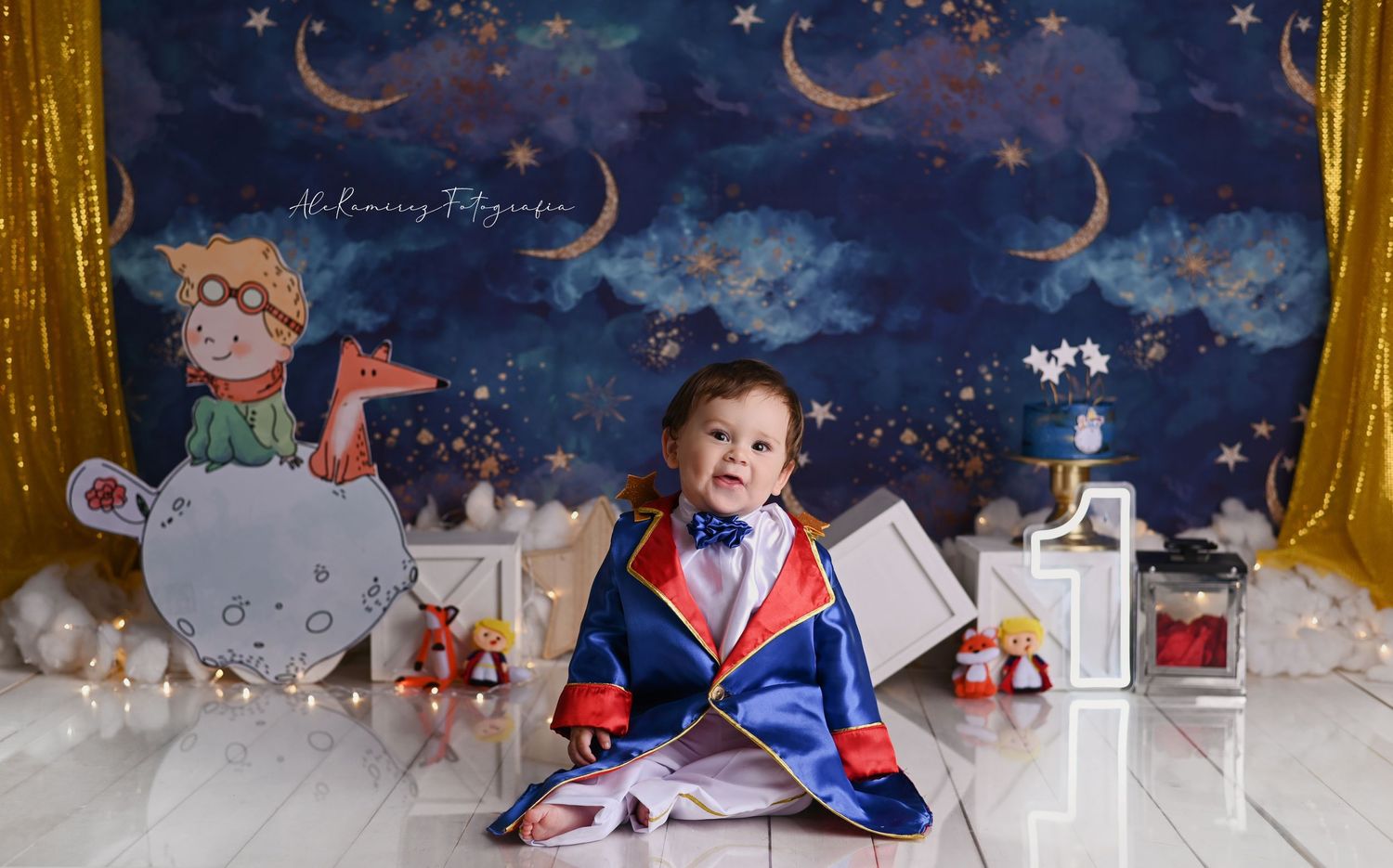 A dreamy nighttime themed nursery photo setup with stars, moons and clouds against a dark blue backdrop with toys and decor.