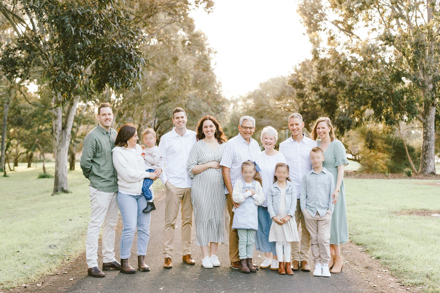 Group photo of people wearing coordinated blue and white outfits in park setting.
