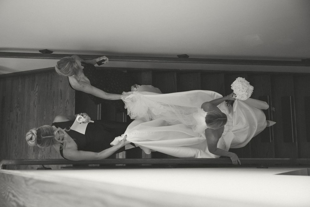 Vintage black and white photo showing a person lying down in a hospital bed or medical examination room.