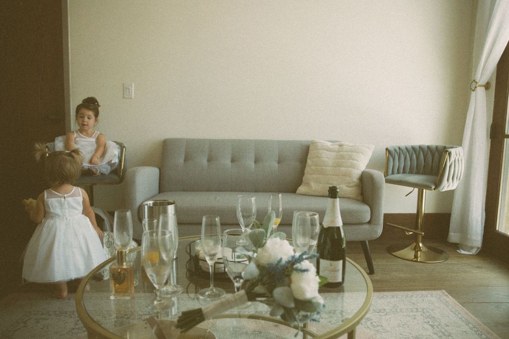 Wedding reception details with champagne glasses and decor in modern room.