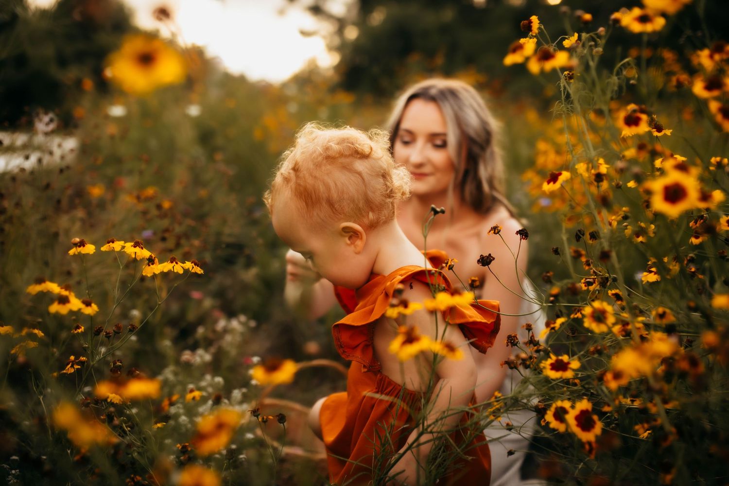 mommy + daughter session in a wildflower field picking flowers