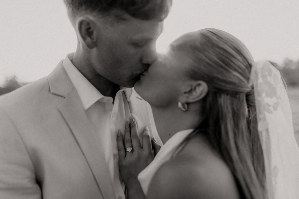 Romantic black and white portrait of a couple sharing an intimate moment during their wedding.