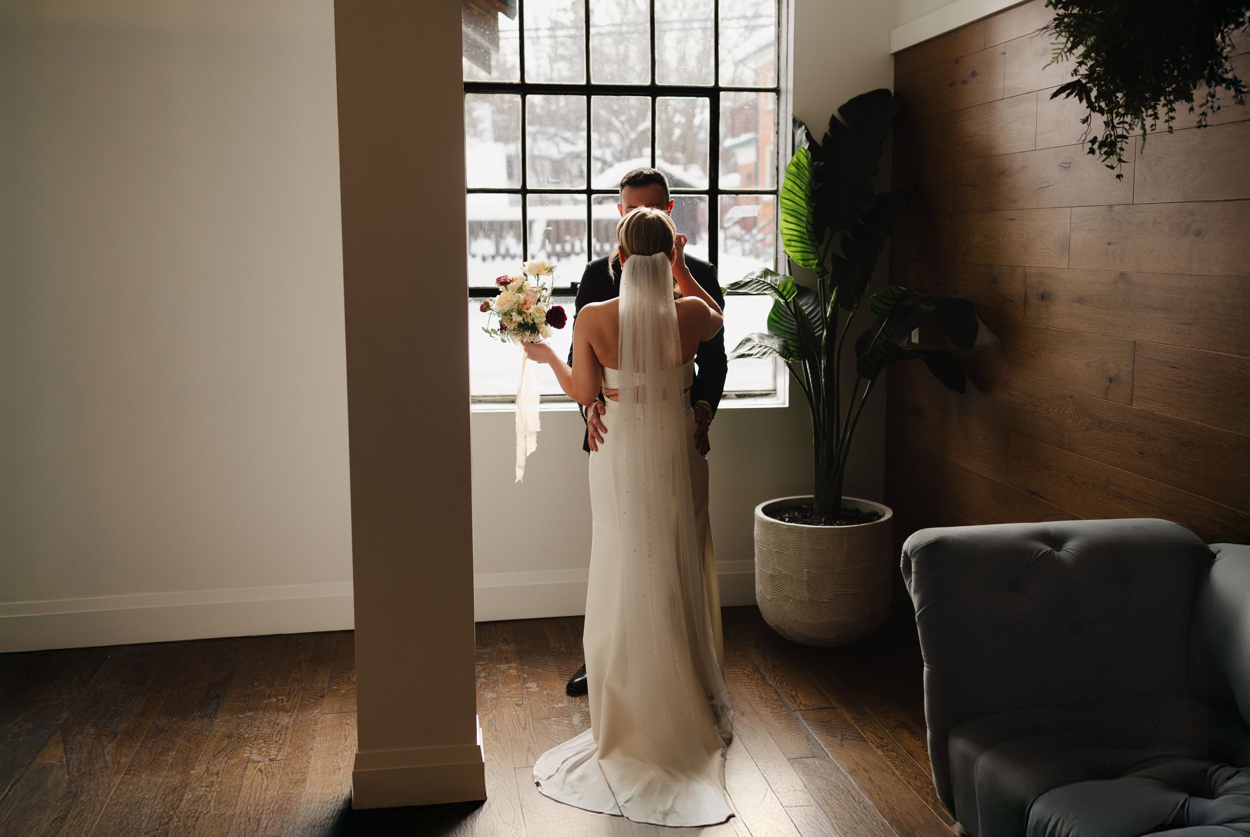 A romantic wedding photo series showing intimate moments between a couple in a sunlit indoor venue.
