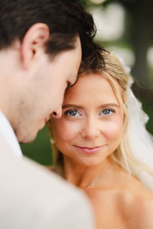 Intimate close-up portrait of wedding couple sharing a tender moment.