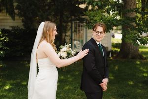 A couple shares a romantic moment together in a lush garden setting during their wedding celebration.