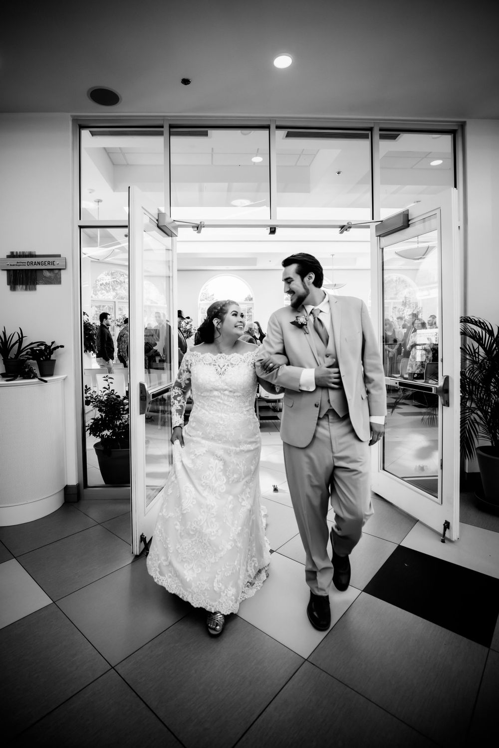 Bride and groom walk out of wedding together smiling at eachother in Dickson, TN
