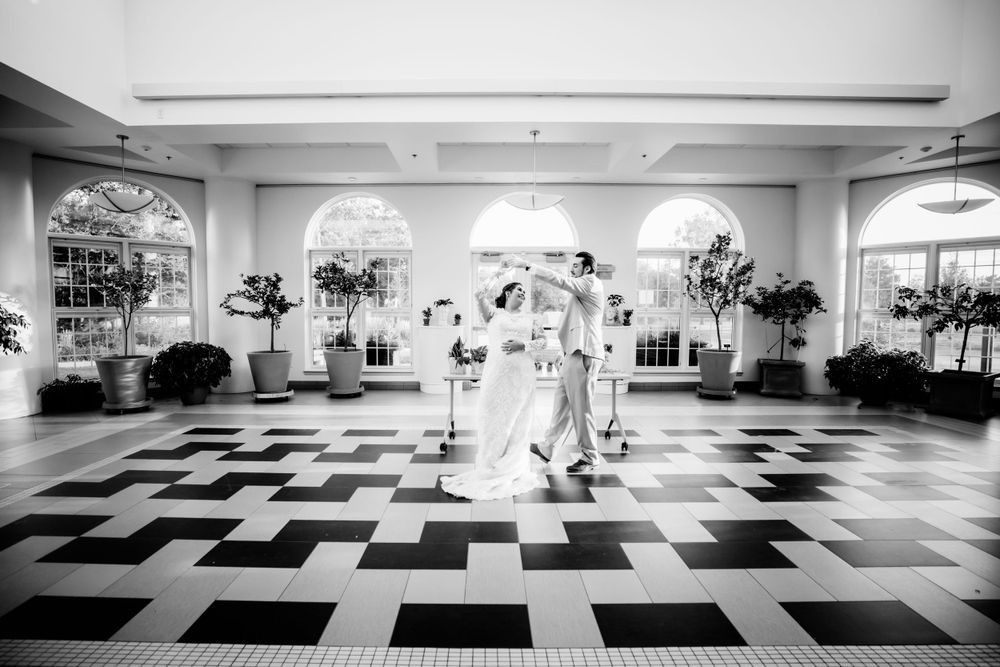 Bride and groom dancing in black and white tiled room in Cheyenne, WY