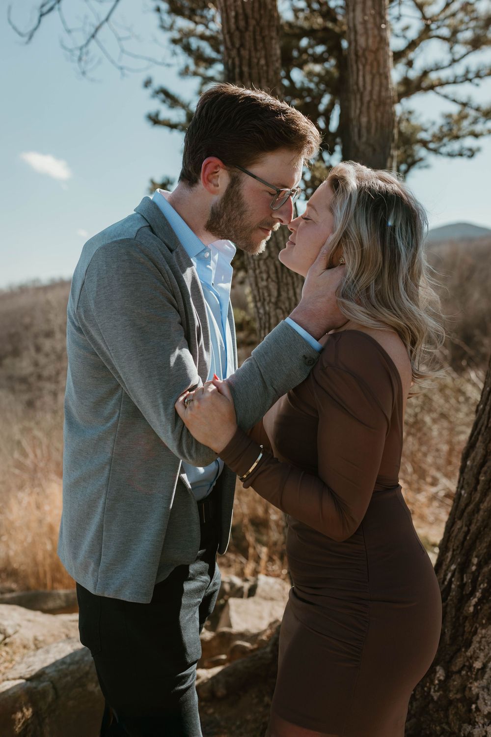 A romantic outdoor photo sequence showing a couple embracing against a tree in autumn.