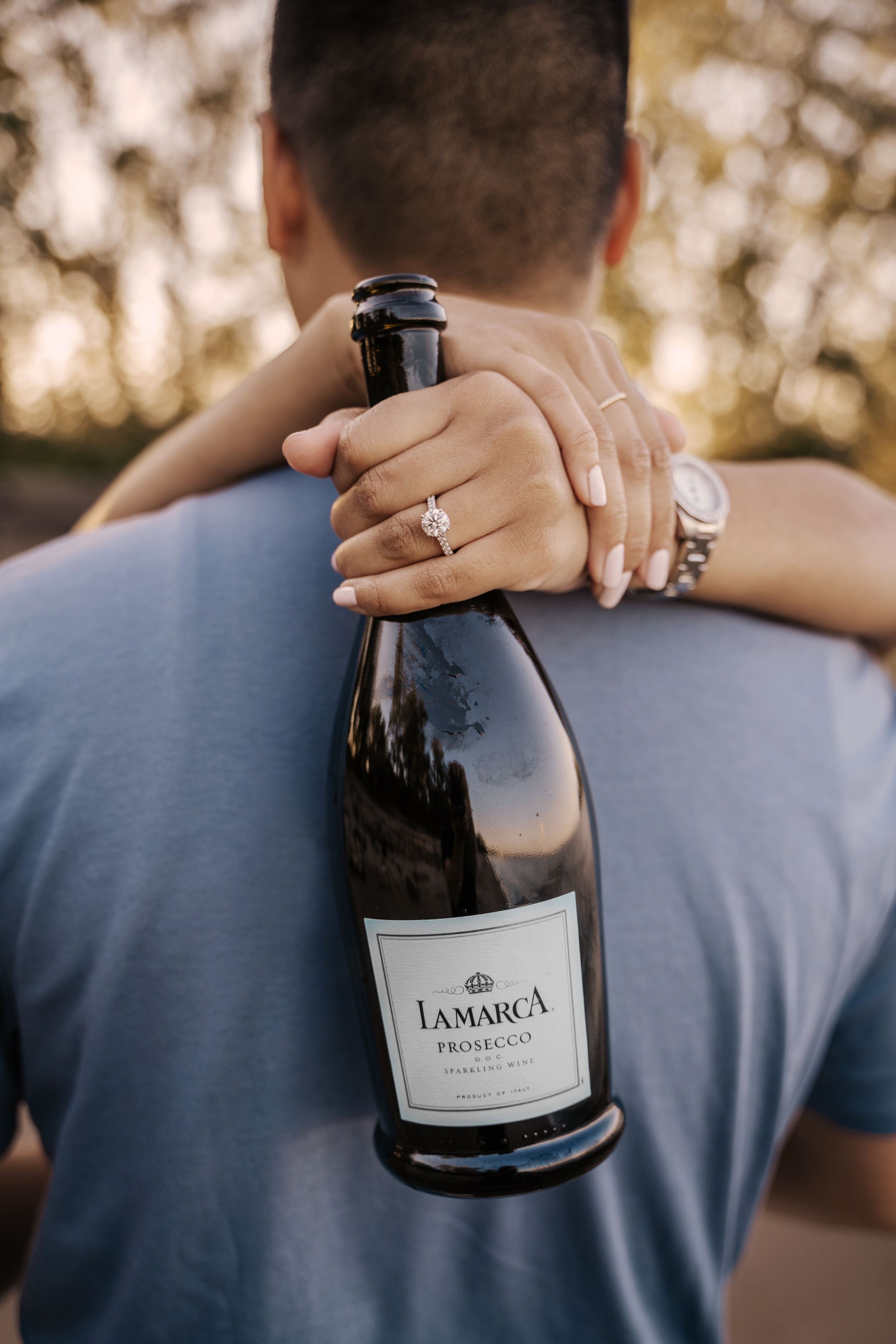 A sequence of photos showing a wine bottle being held against a blue shirt in natural outdoor lighting.