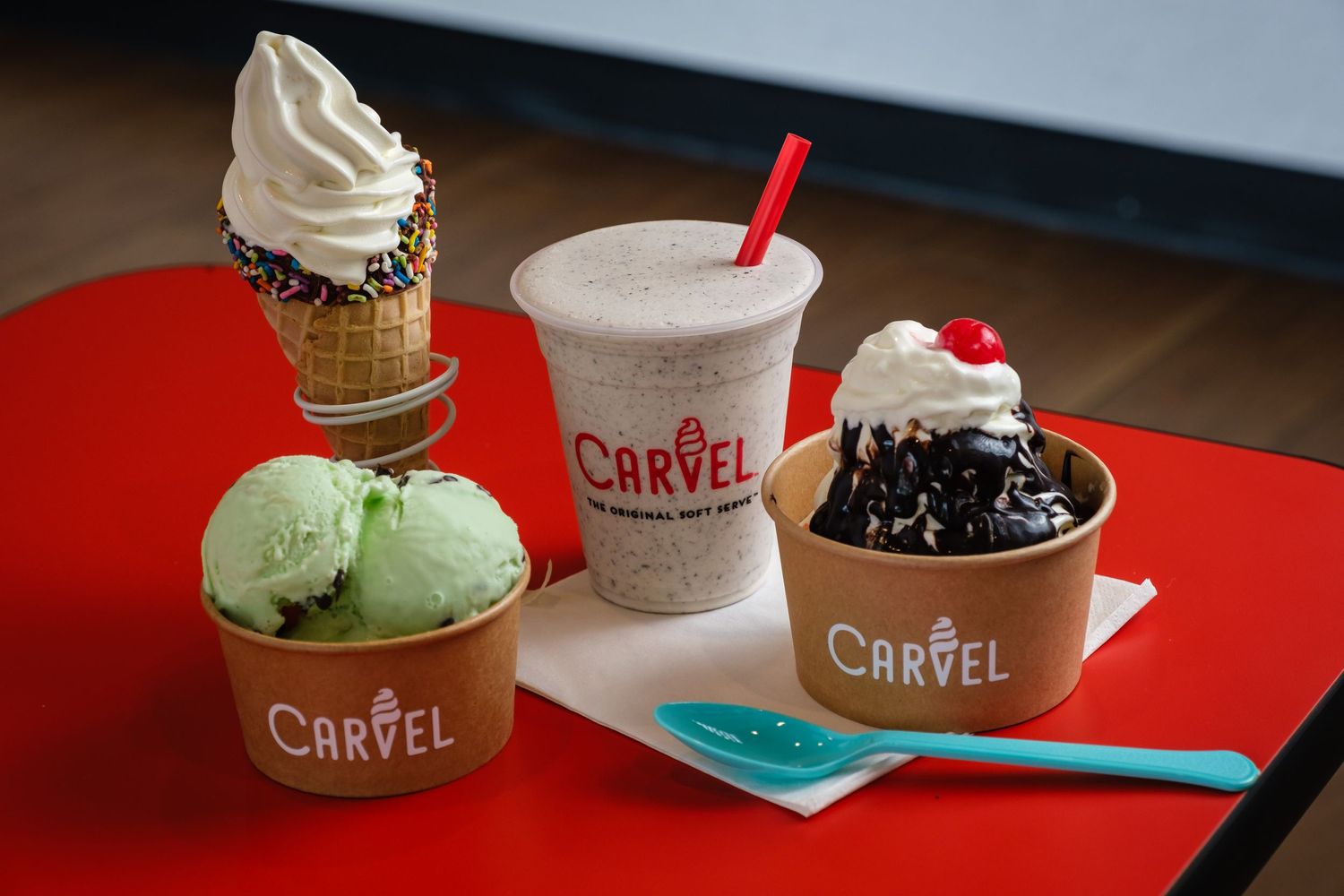 Photograph of Carvel soft serve ice cream products on a red table.