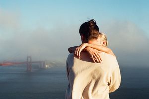 Romantic Golden Gate Bridge proposal photography in San Francisco captured on 35mm film with a candid documentary style