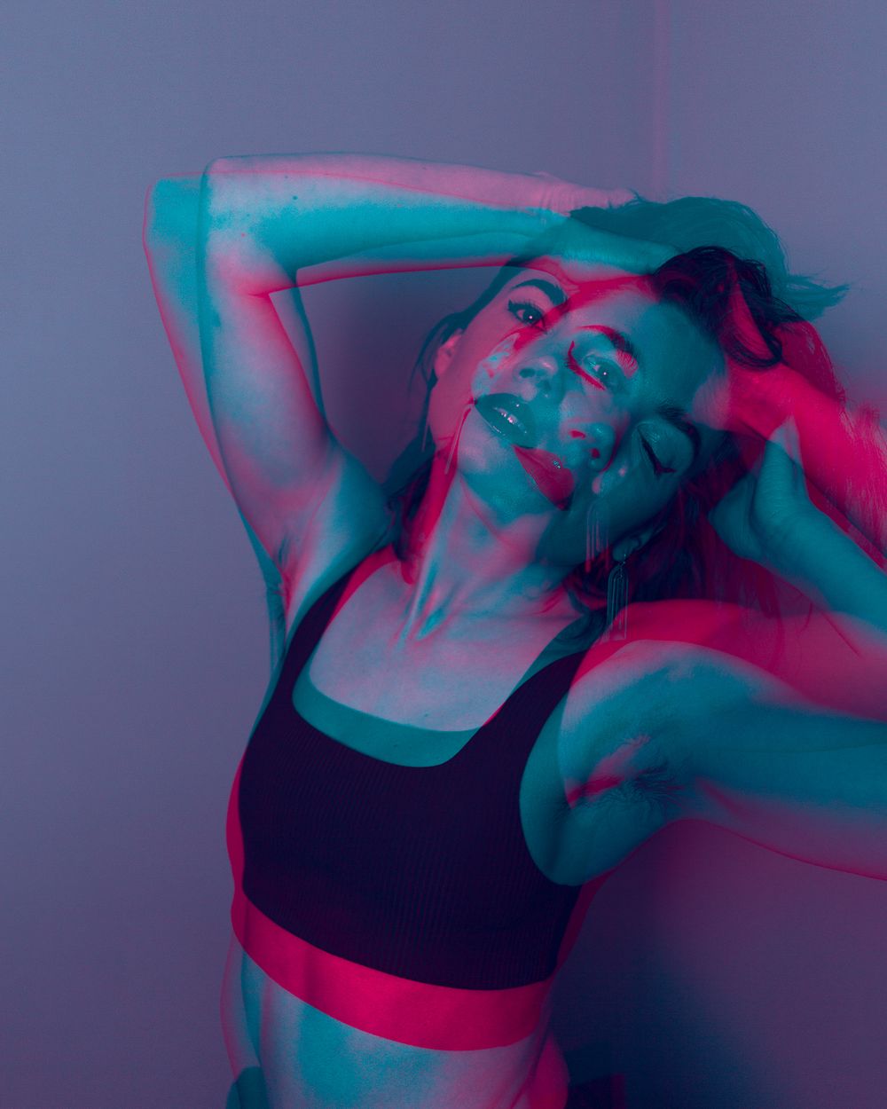 Portrait photography: double exposure portrait of a woman leaning back with her hands in her hair