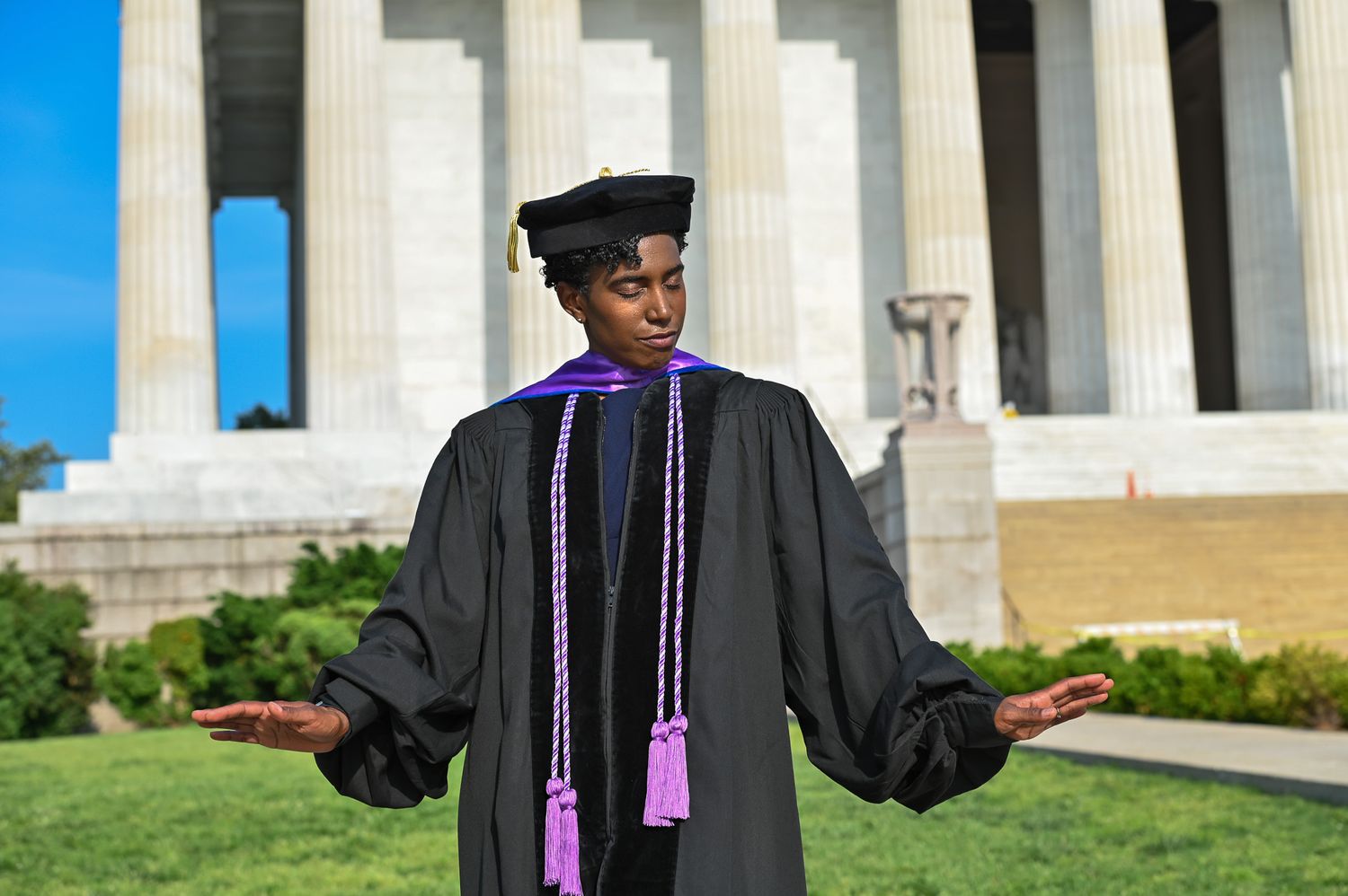 Graduate holding hands out