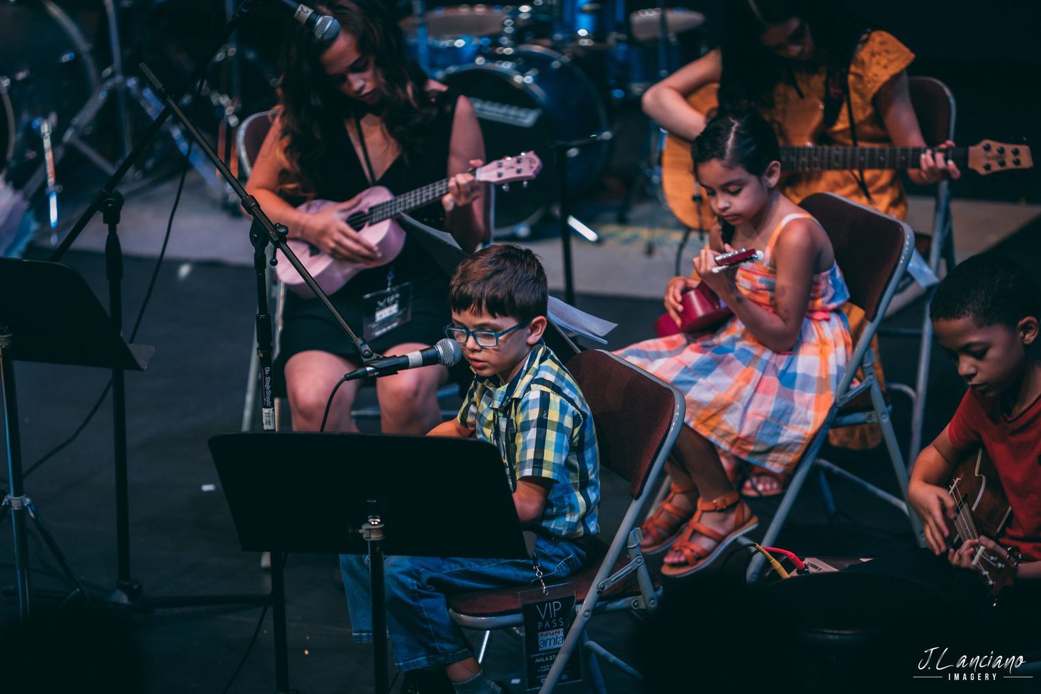 Musicians performing on acoustic guitars during a live concert on stage.