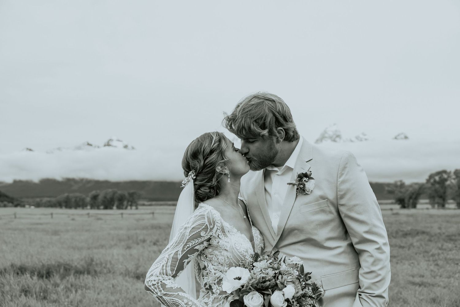 Black and white wedding photo series showing romantic moments in a field.