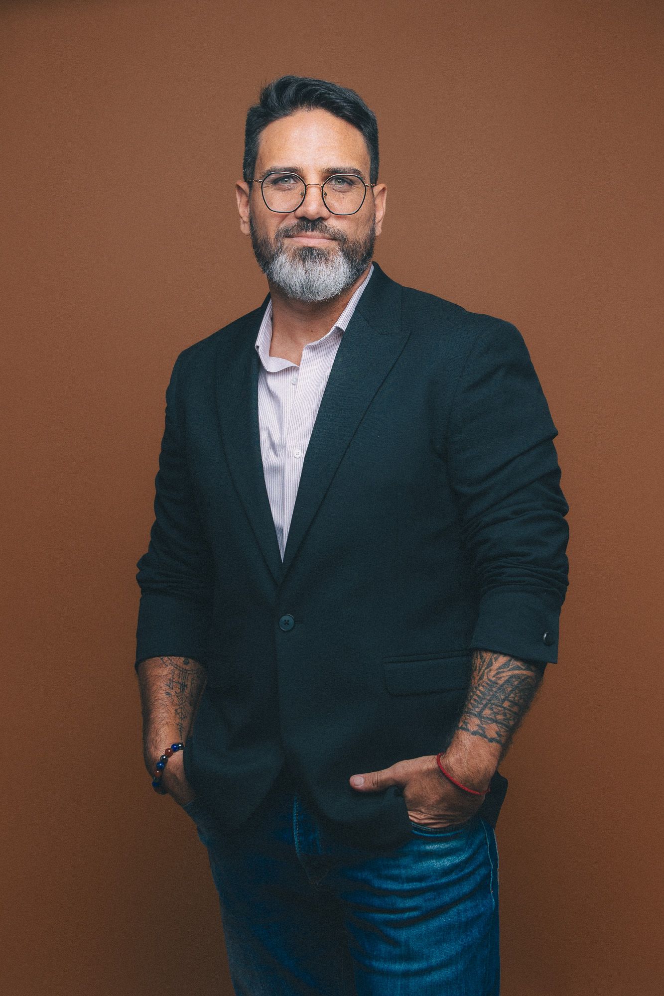 Professional studio portraits against brown background showing confident poses in business attire.