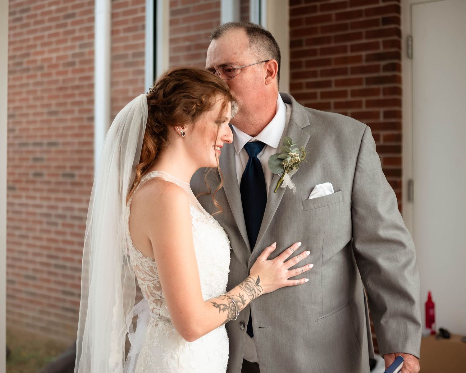 Emotional first look moment between couple in wedding attire.