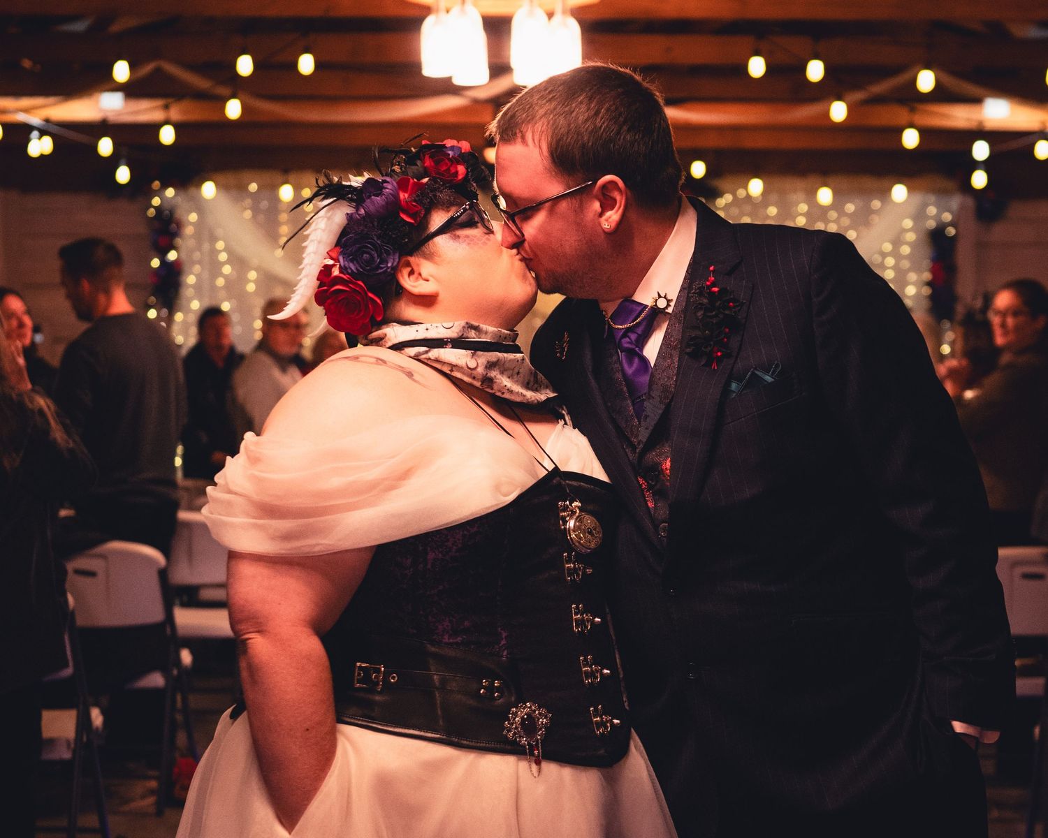Wedding couple shares intimate dance moment under warm lighting at reception venue.
