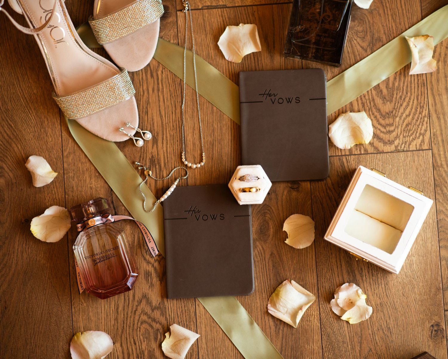 Wedding details and decorations arranged on rustic wooden table surface.