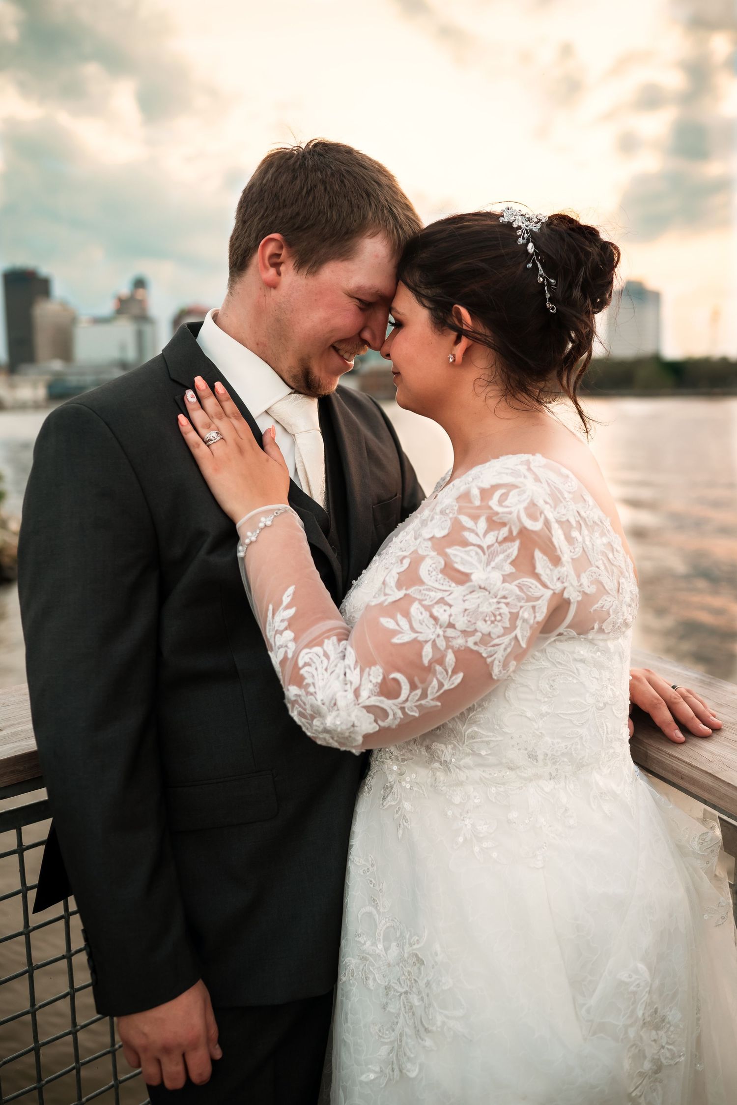 Romantic waterfront wedding photos capturing intimate moments between the newlyweds.