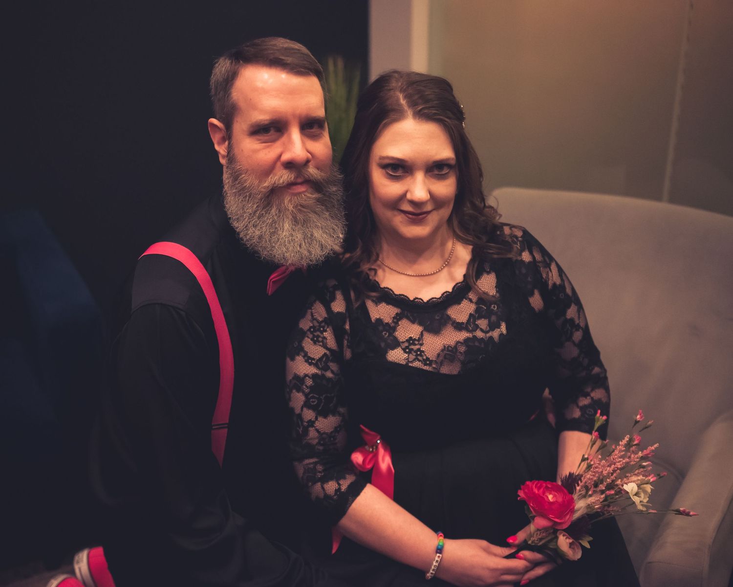 Couple in formal attire sharing intimate moments during indoor photo session.