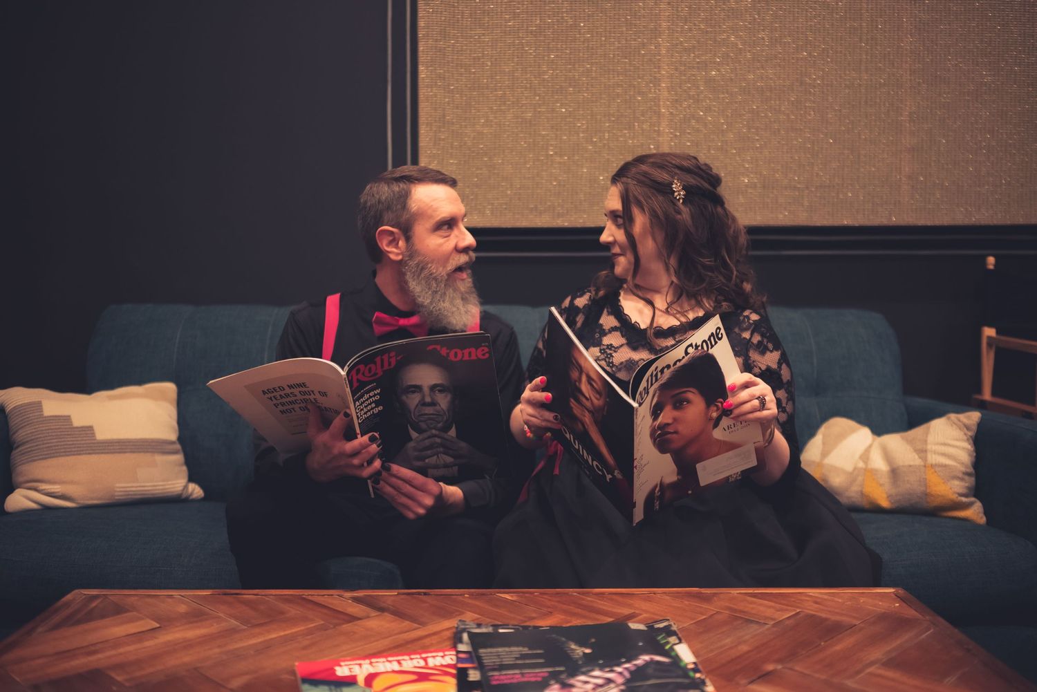 Romantic indoor photo session with couple on couch in formal attire.