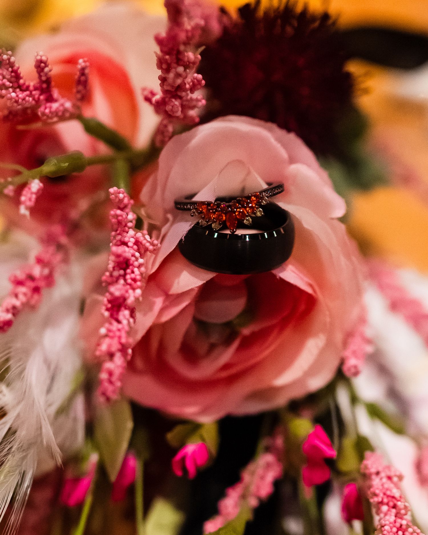 Close-up detail of pink and red floral arrangements with delicate sparkly accents.