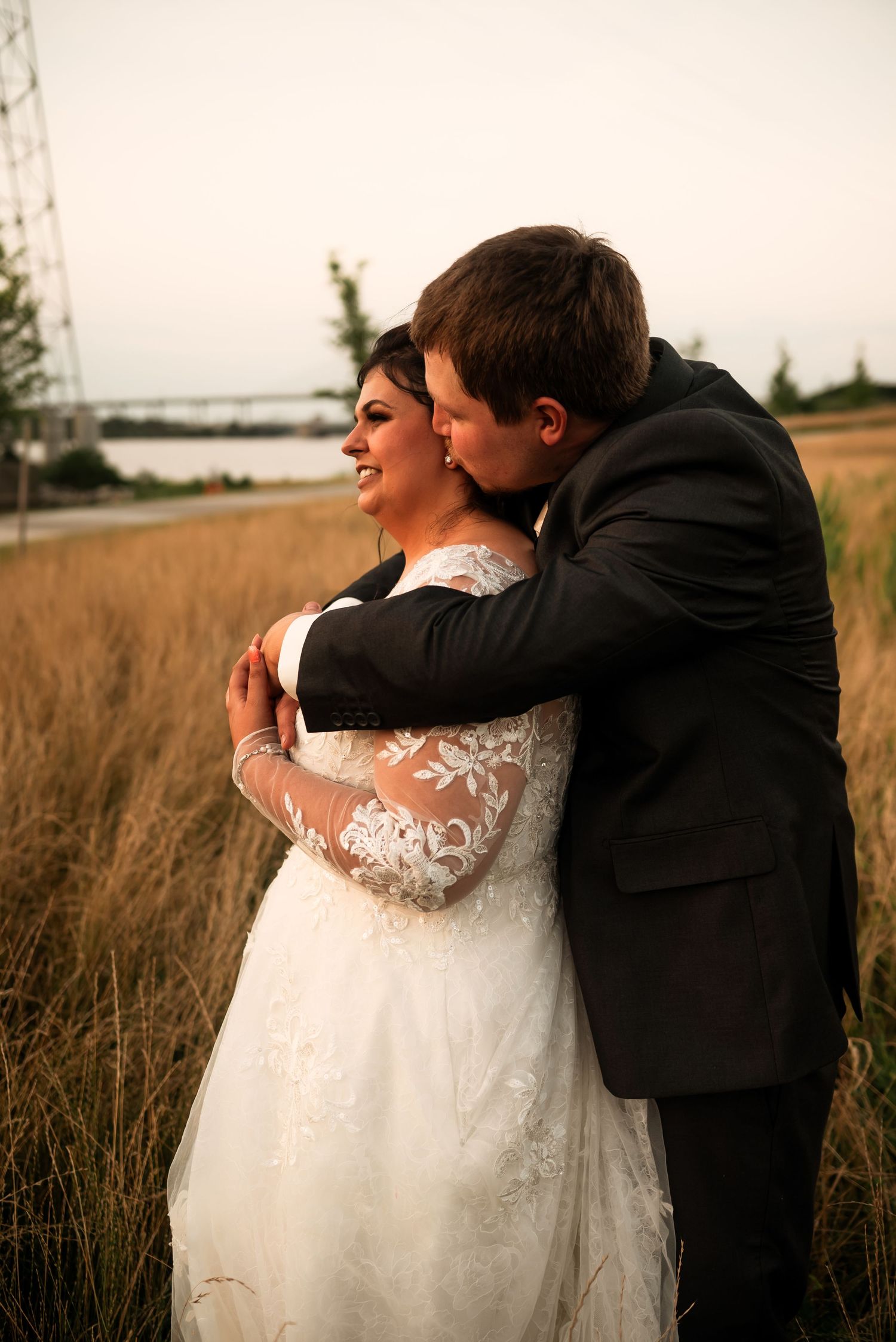 Intimate couple portraits in golden field during sunset wedding photography session.