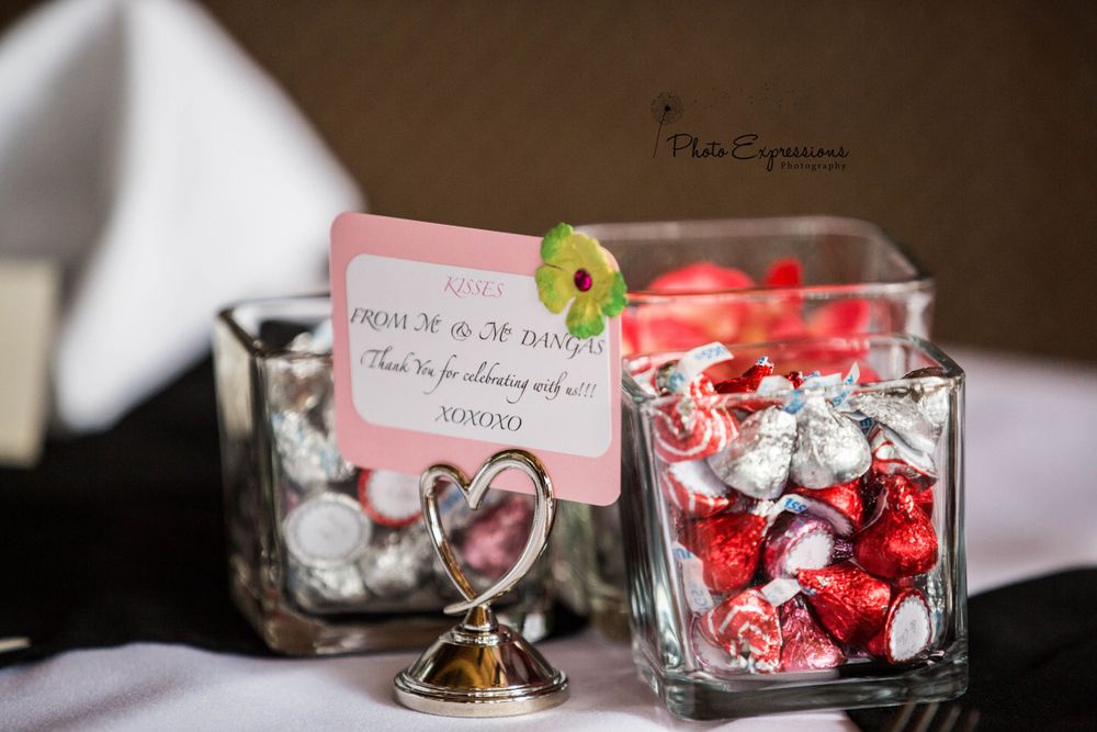 Wedding favor boxes and decorative details displayed on a dark surface.