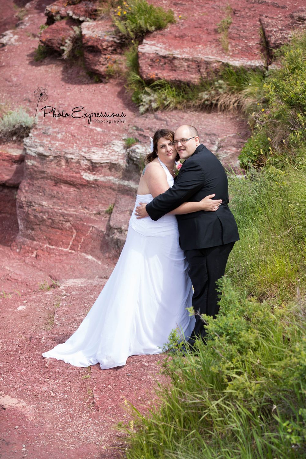 Wedding portraits taken against striking red rock formations in nature.