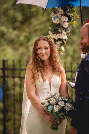 Intimate outdoor wedding ceremony with delicate floral arrangements and soft lighting.