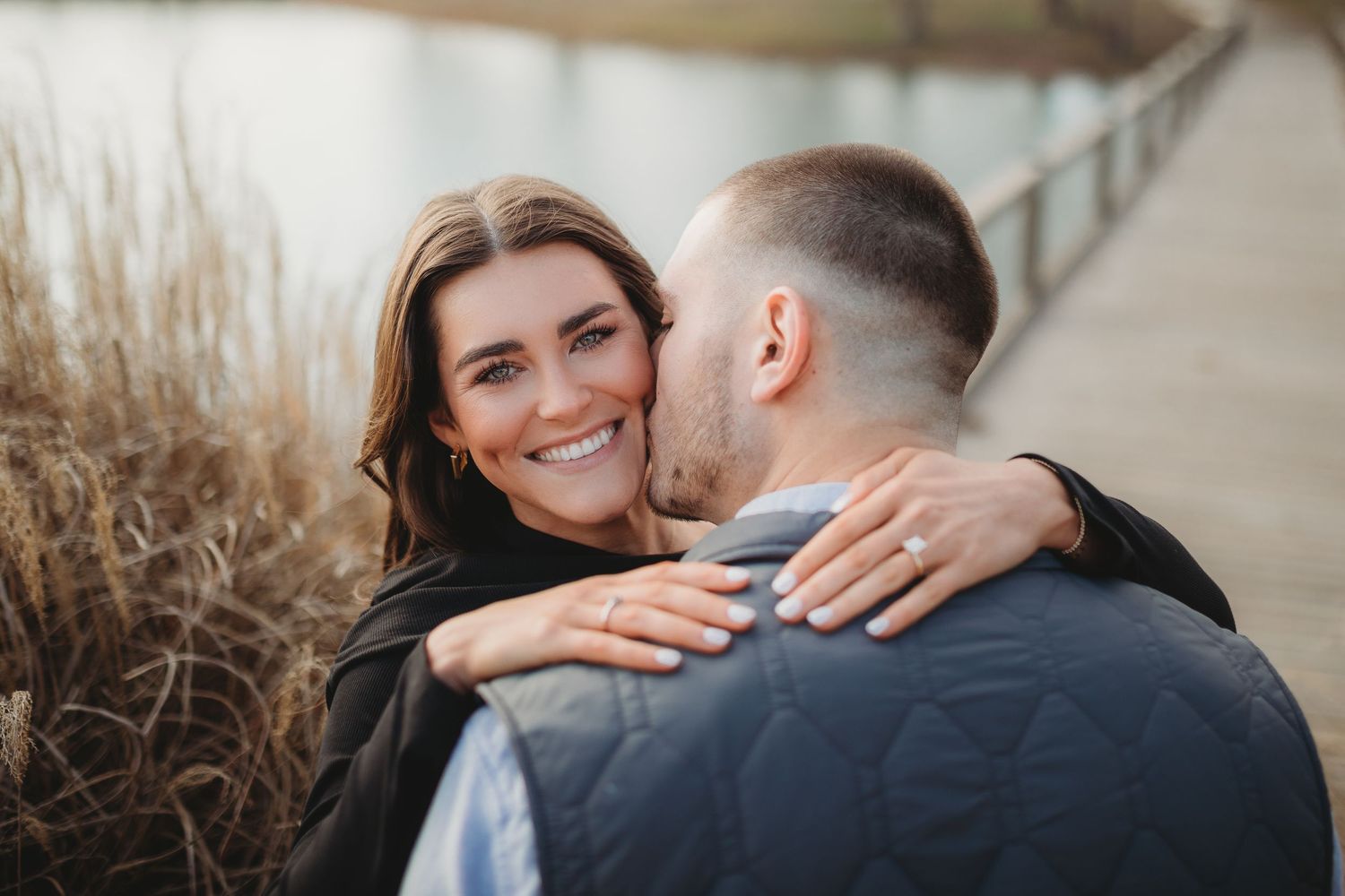 Intimate engagement photos captured in soft natural light showing ring detail.